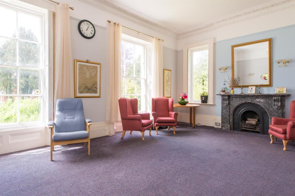 Lot: 151 - SUBSTANTIAL FORMER CARE HOME WITH POTENTIAL - Internal room with fireplace and large windows